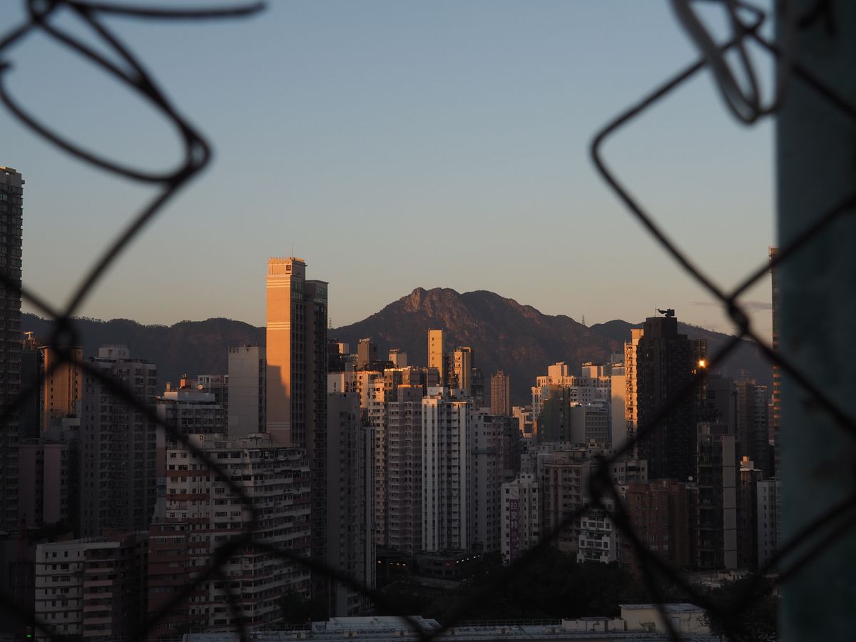 Hong Kong skyline with Lion Rock at sunset, a popular Chung Yeung Festival hiking destination
