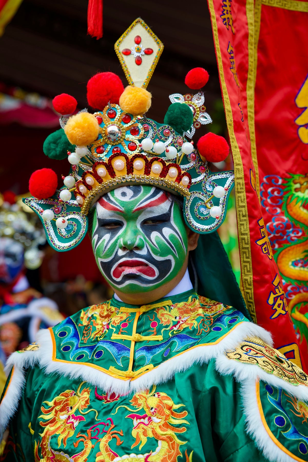 Chinese opera performer in elaborate traditional costume and painted makeup