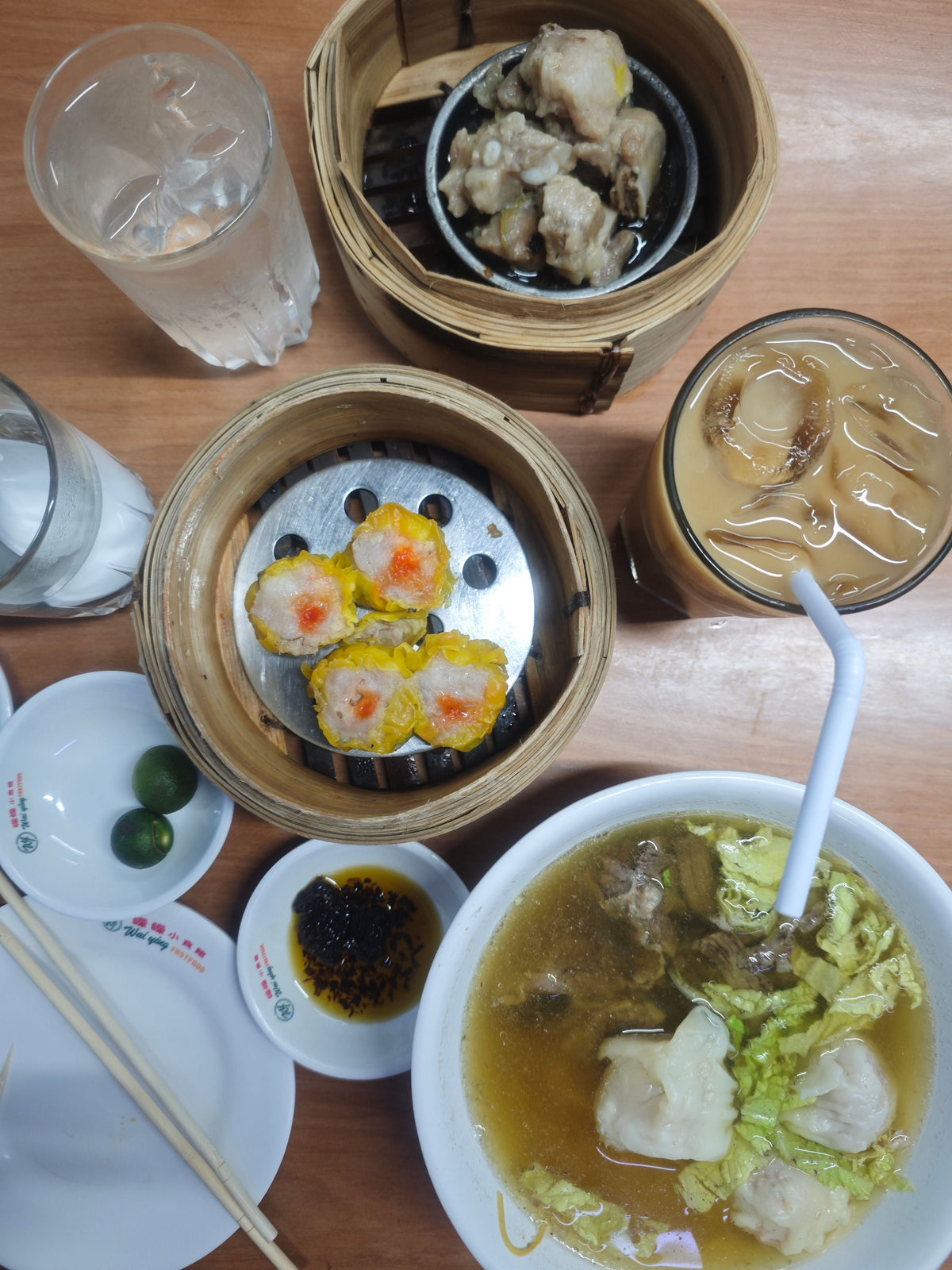 Overhead view of Cantonese dim sum spread with siu mai and dumplings on a table