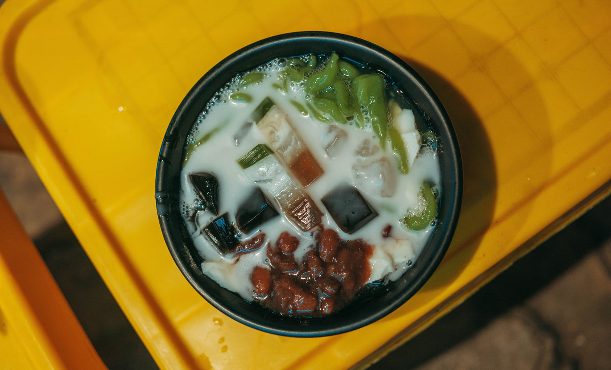 Asian dessert with jelly cubes in a dark bowl