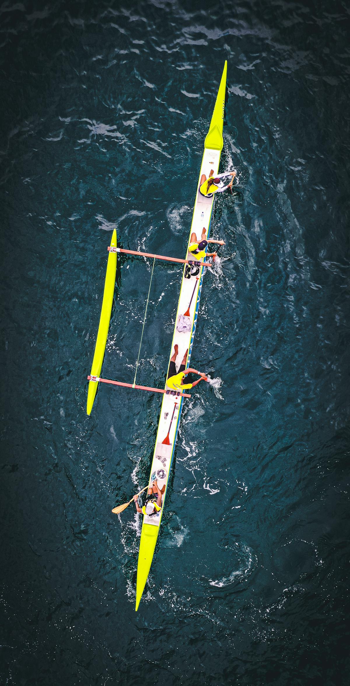 A team of paddlers racing in a long boat on open water