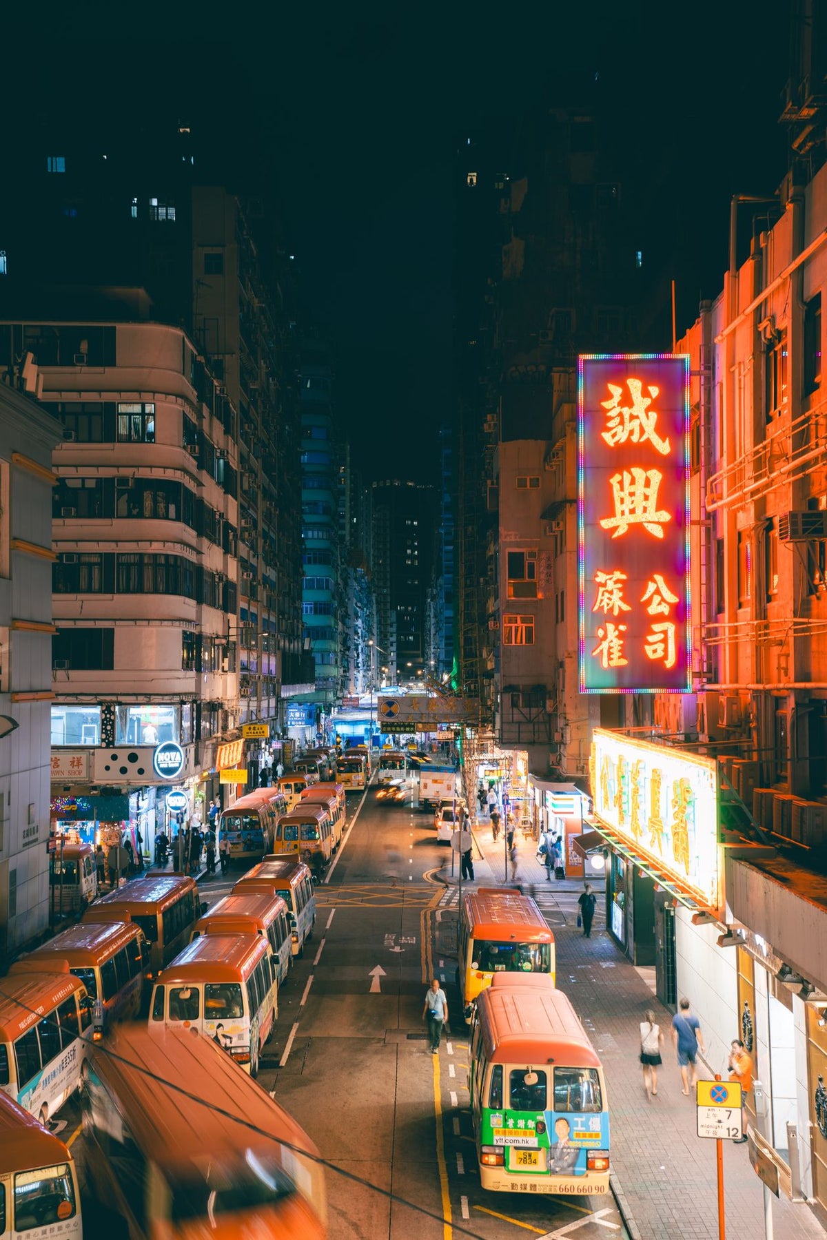 Lively Hong Kong street with neon lights and nightlife atmosphere, evoking the era of the Four Heavenly Kings