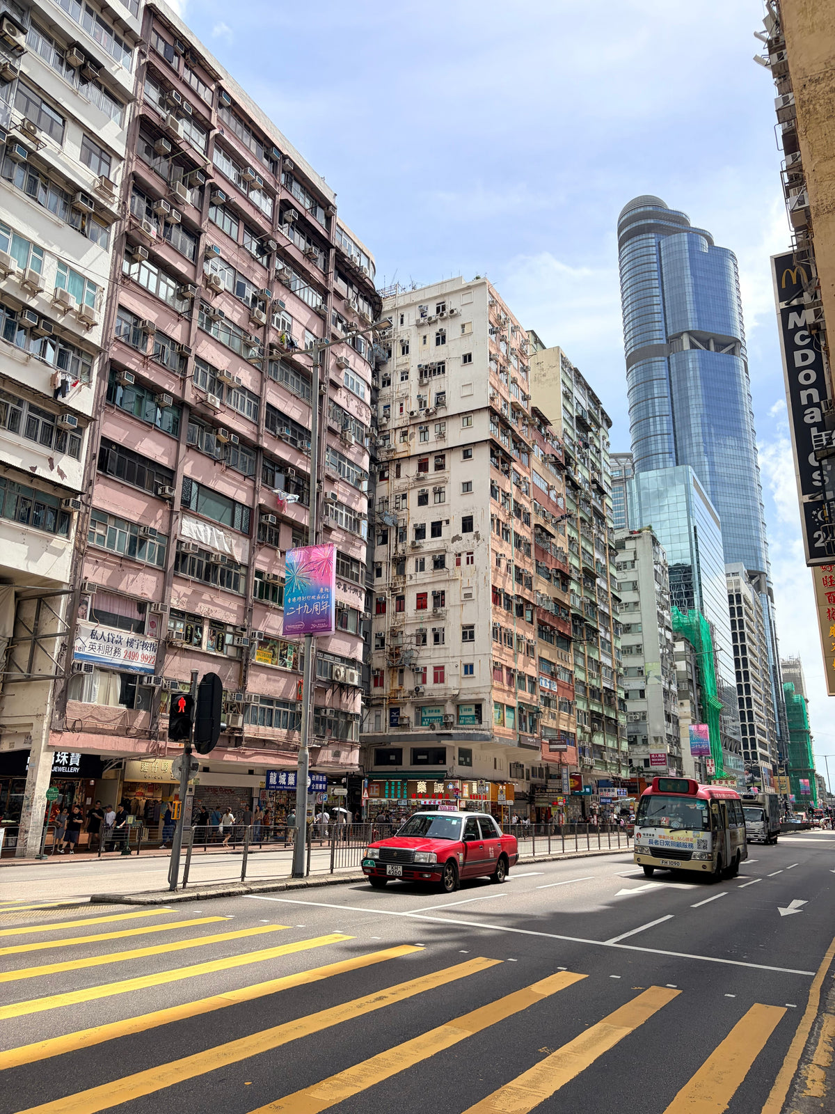 A busy Wan Chai Hong Kong street with historic buildings and modern skyscrapers