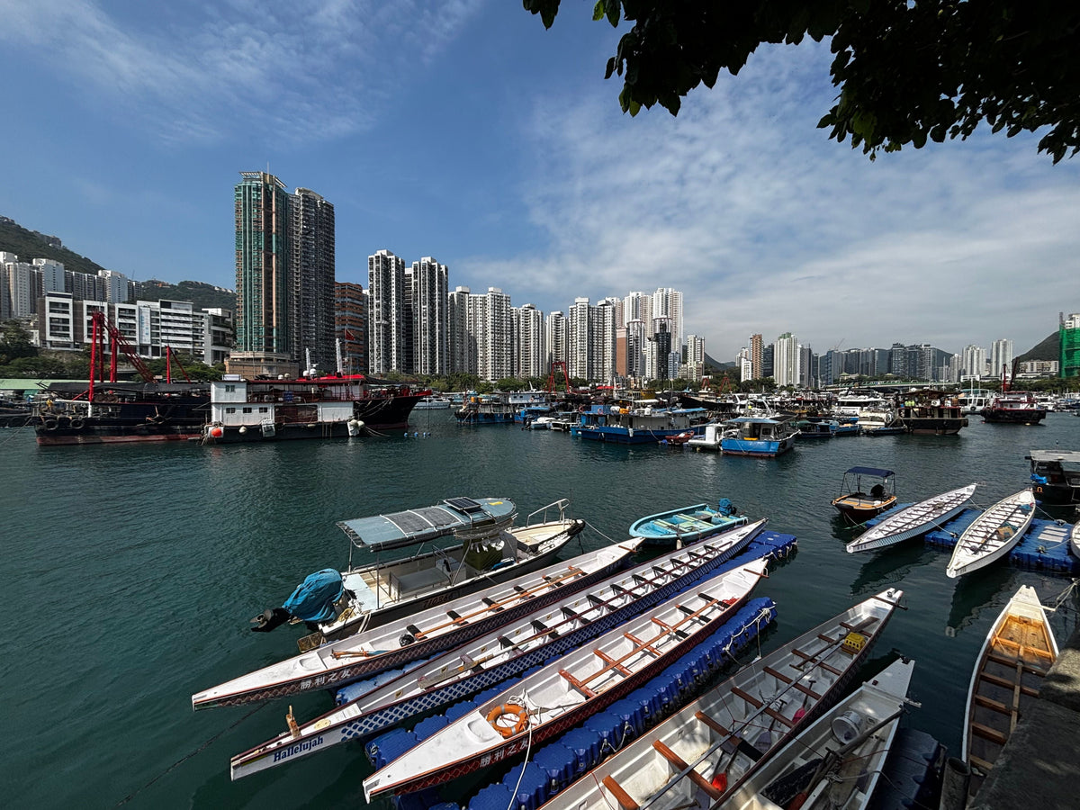 Aberdeen Harbour Hong Kong with dragon boats and skyscrapers