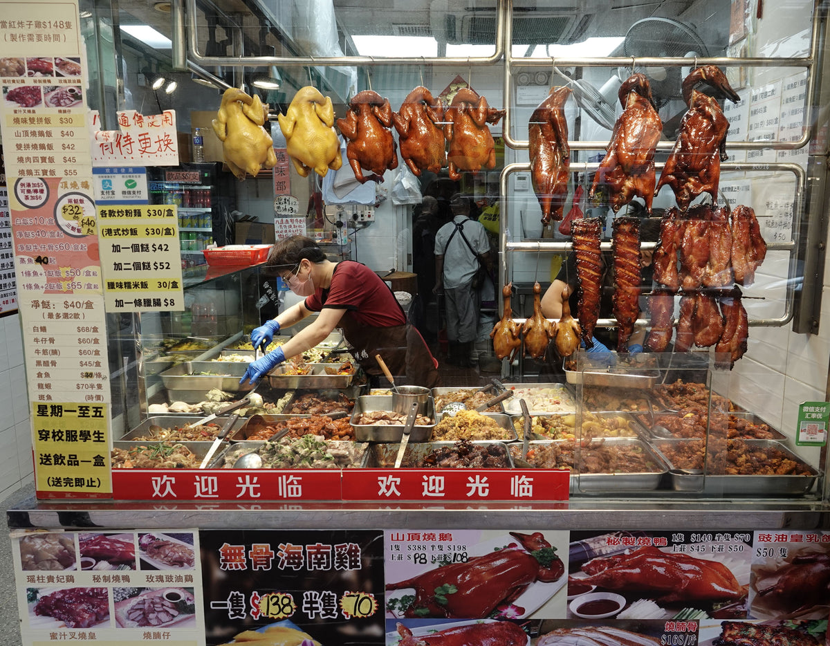 Hong Kong Cantonese roast meat shop stall in Kowloon with hanging bronze-skinned roast meats