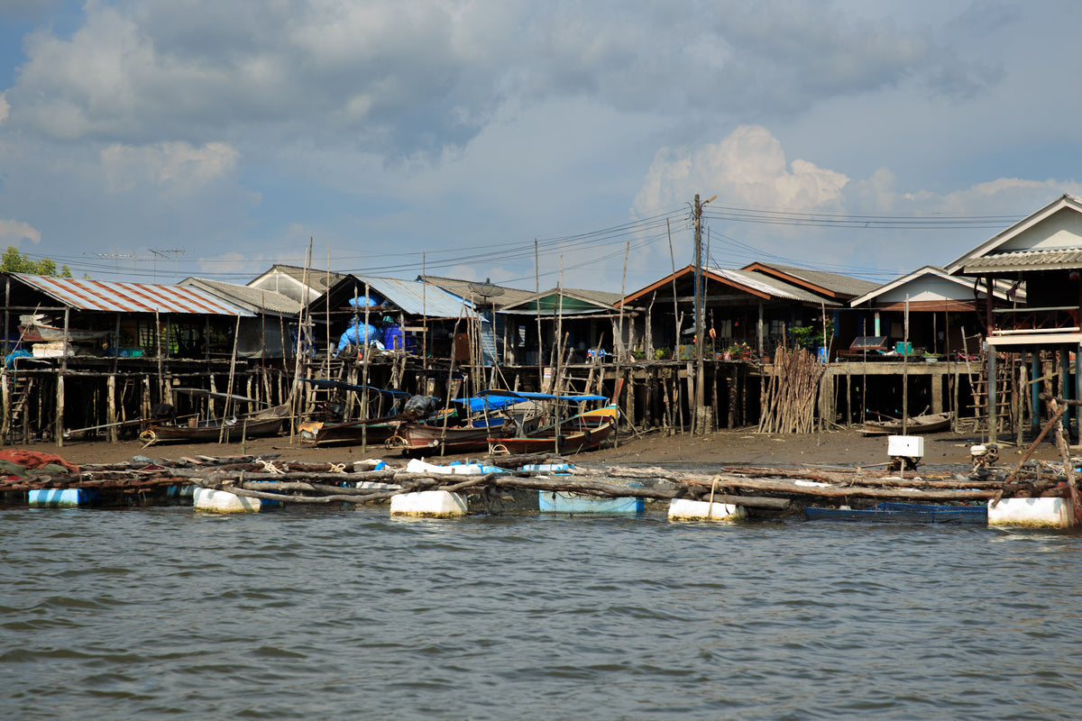 Rustic wooden stilt houses along the waterfront of a traditional fishing village