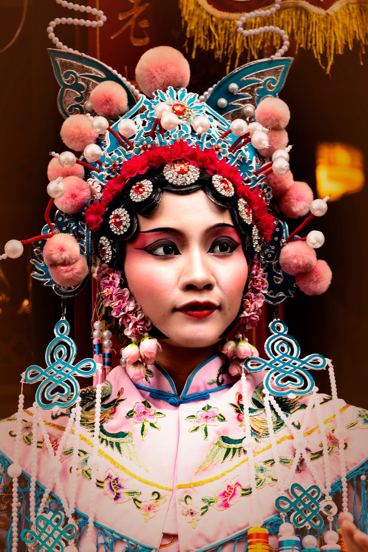 Close-up portrait of a Chinese opera performer in vibrant traditional attire and face makeup