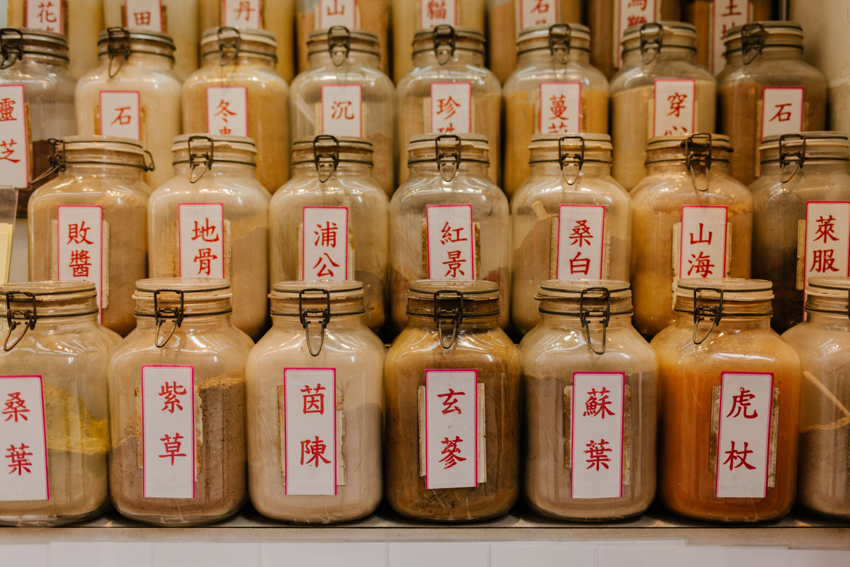 Herbal medicine jars with Chinese labels displayed in a shop