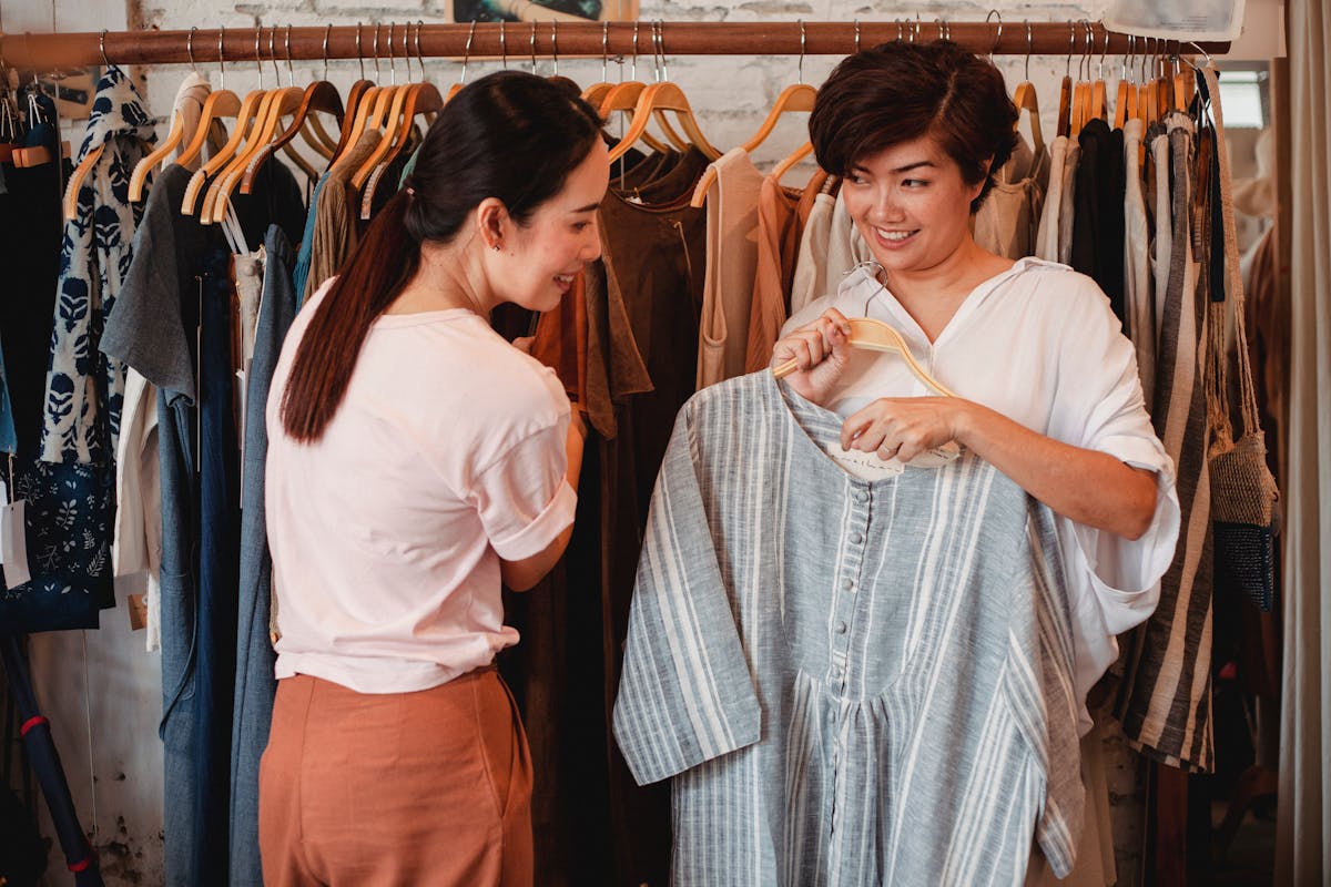Asian shoppers browsing Cantonese streetwear in a clothing store