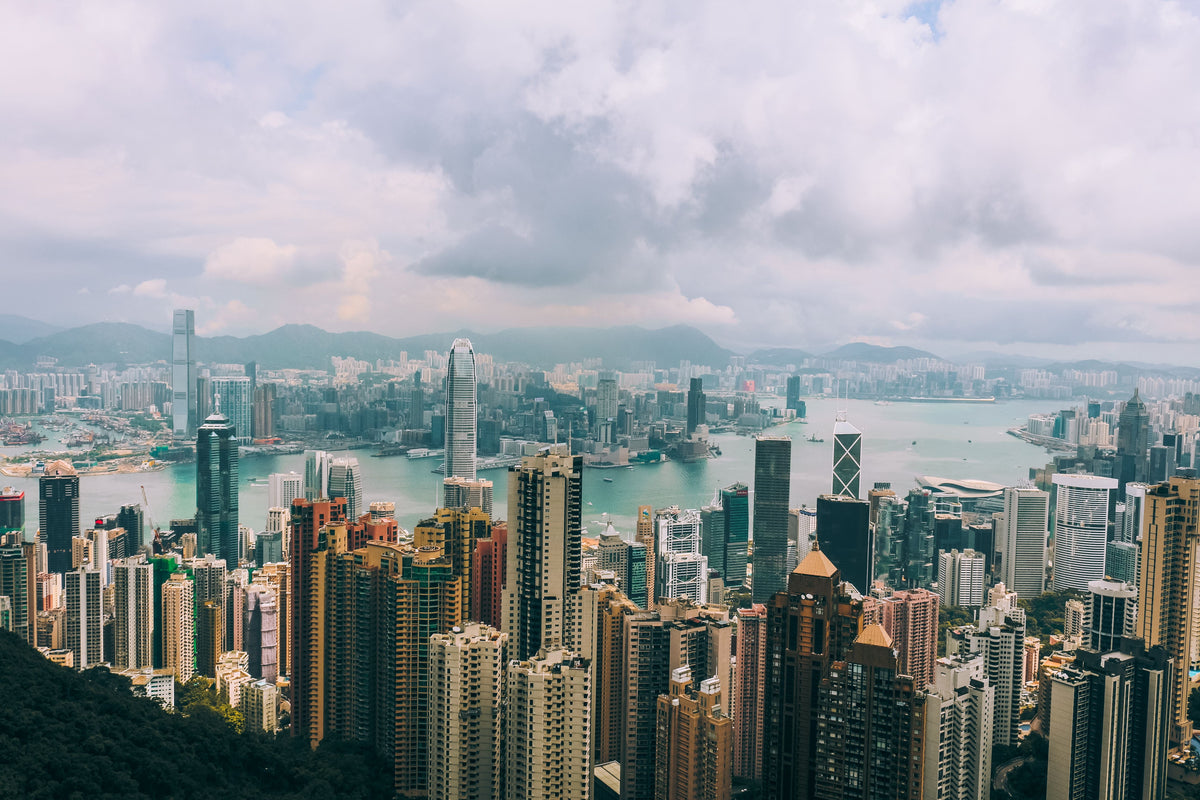 Panoramic Hong Kong skyline and Victoria Harbour seen from Victoria Peak — the view the Peak Tram climbs to reach
