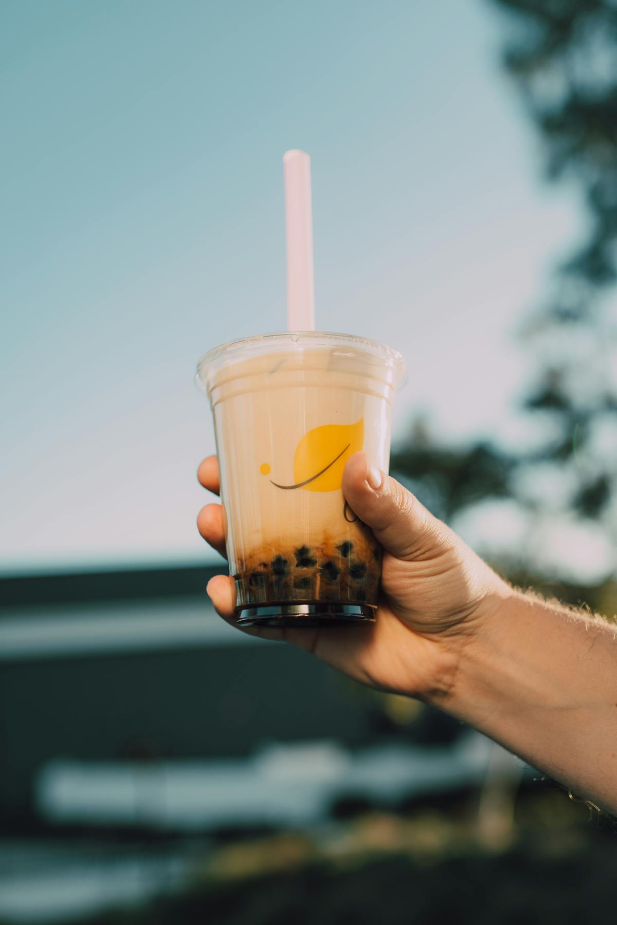 Person holding a cup of tea drink