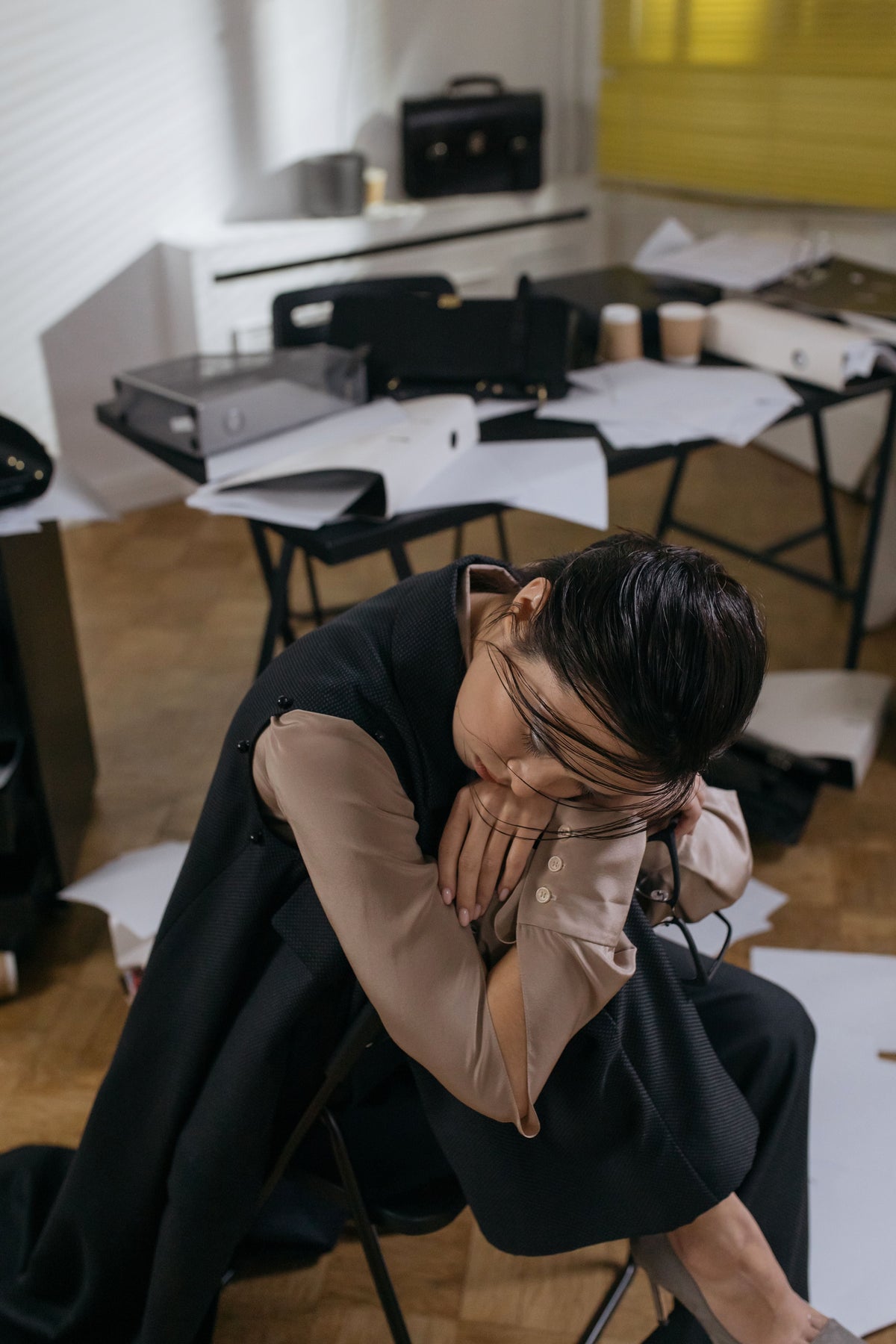 Exhausted office worker leaning on a desk in a Hong Kong office