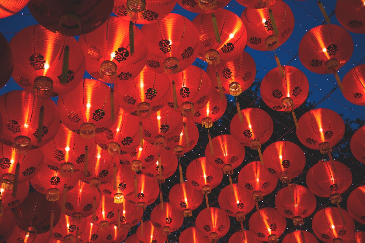 Bright red Chinese lanterns glowing against the night sky during Lunar New Year