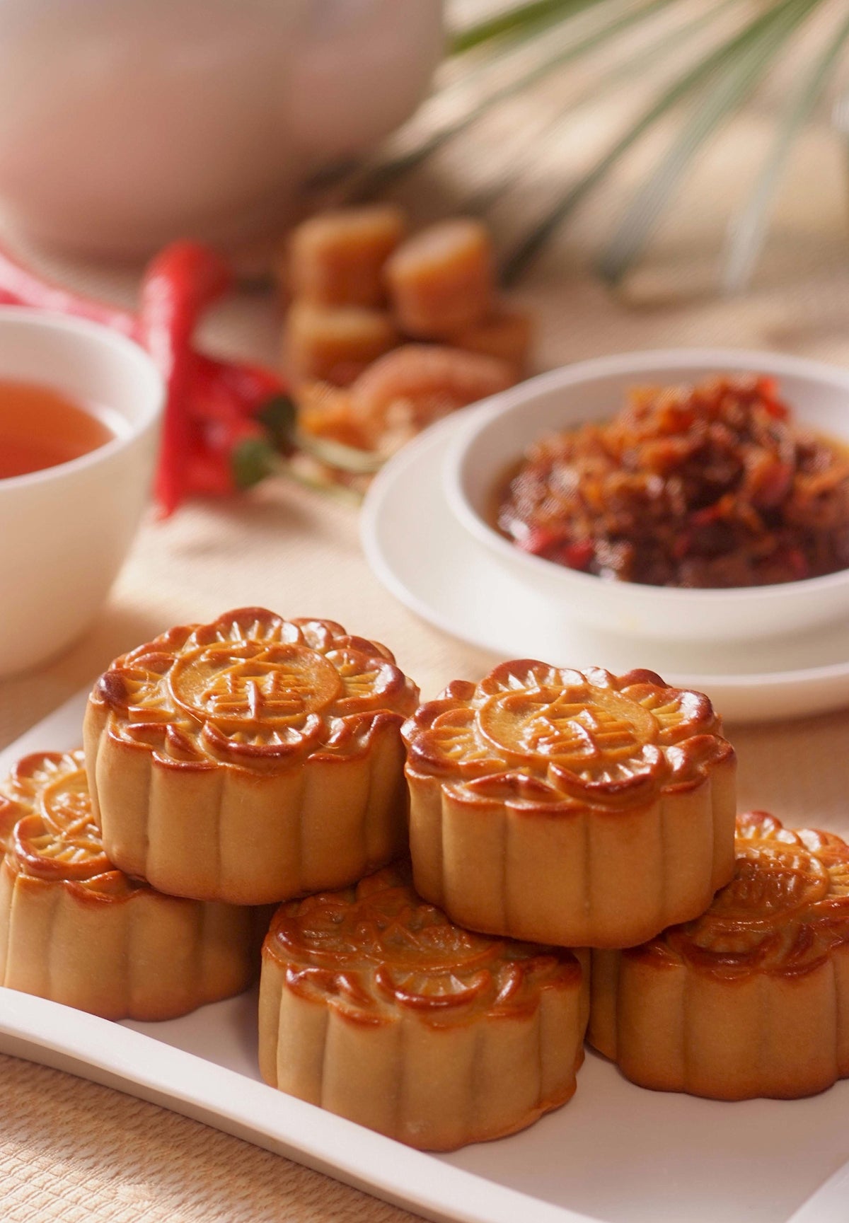 Stack of traditional round golden Chinese pastries presented together