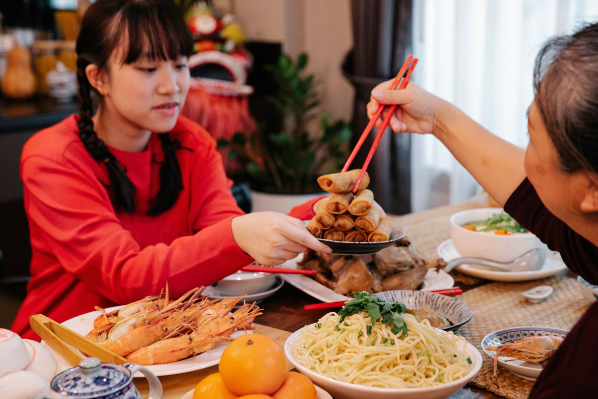 Cantonese family gathered around a dining table for a Lunar New Year reunion