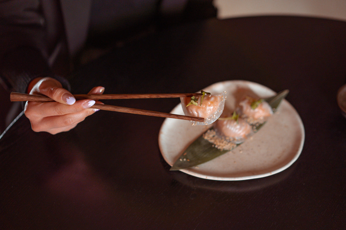 Elegant Chinese dessert served with chopsticks on a decorative plate, representing traditional Cantonese dessert culture