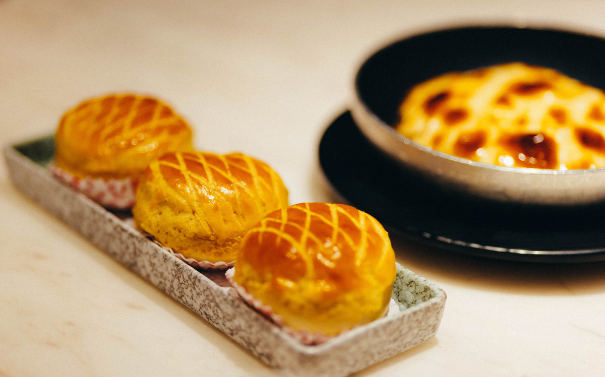Close-up of freshly baked Chinese pineapple buns bo lo bao with golden crackled sugar crust